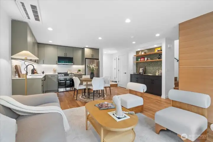 Well-appointed living room with hardwood floors, mini-split for efficient heating and cooling, and custom cabinetry. Photo of model unit, 4118. Finishes may vary, buyer to verify.