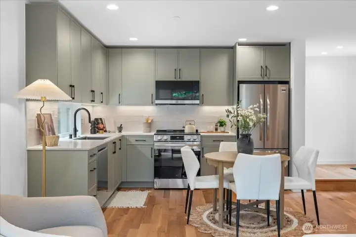 Well-appointed kitchen with custom cabinets, SS appliances, and stylish backsplash. Photo of model unit, 4118. Finishes may vary, buyer to verify.