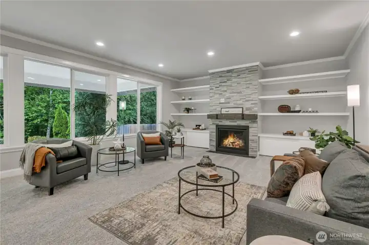 Enormous Family Room with Gas Fireplace; TV Wiring Hidden Behind the Tiled Surround and Accessible Through the Built-In Shelves
