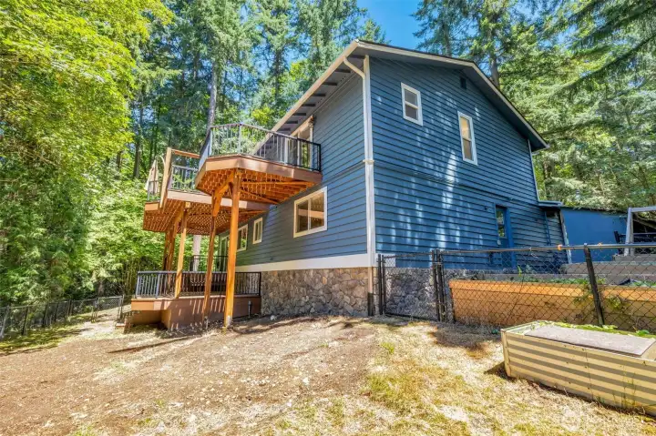 Back of home with multiple decks on each level