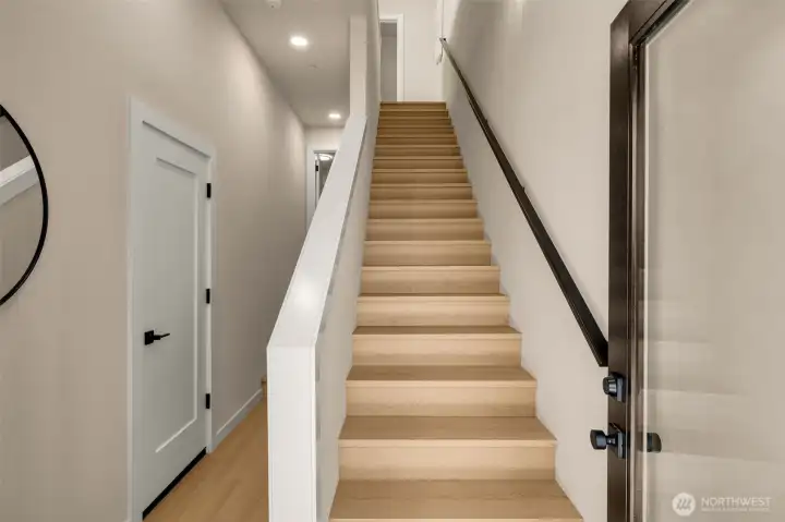 Inviting formal entryway featuring a beautiful hardwood staircase and elegant accent railing. (photos are of model home- similar finishes and layout) Inviting formal entryway featuring a beautiful hardwood staircase and elegant accent railing. (photos are of model home- similar finishes and layout)
