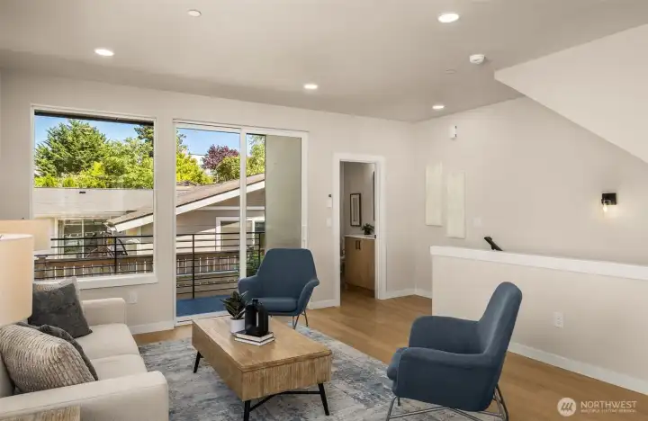 Another view of the spacious living area, seamlessly transitioning toward the upper levels—perfect for entertaining. (photos are of model home- similar finishes and layout) Another view of the spacious living area, seamlessly transitioning toward the upper levels—perfect for entertaining. (photos are of model home- similar finishes and layout)