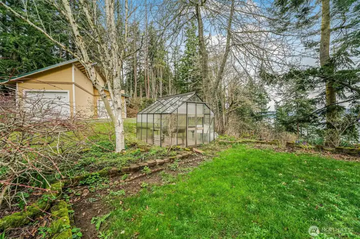 There are multiple outbuildings for your convenience.  One that has fenced space,  others perfect for storage and a bonus greenhouse.
