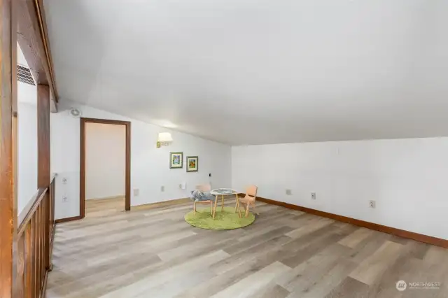 Upper level loft with a large walk in closet is well suited to a home office or a playroom.