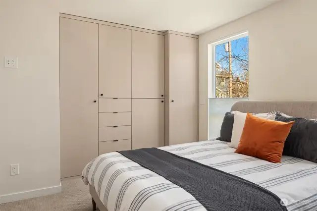 Both bedrooms feature remote controlled blinds for convenience, as well as custom closet built-ins.