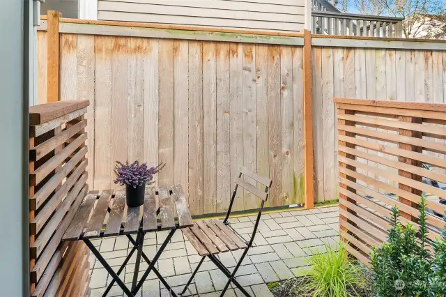 Enjoy a cup of coffee on the private back. Bins and storage shed (comes with property) are concealed behind a privacy wall.