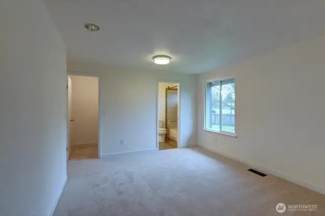 Primary bedroom looking towards the bath and walk-in closet.