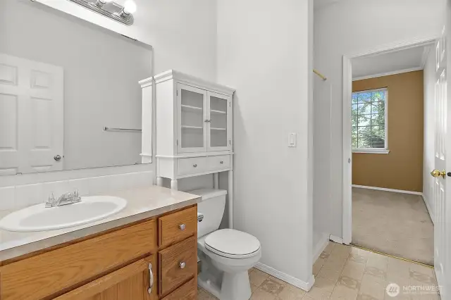 Conveniently located near the secondary bedrooms, this second bath offers a walk-in shower, ample counter space, and added cabinetry for extra storage—perfect for guests or shared use.