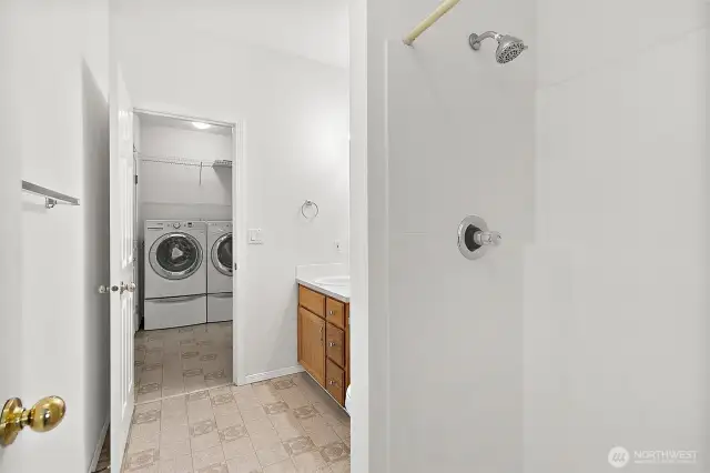 Peeking into the laundry area from the second bathroom—everything right where you need it for everyday convenience.