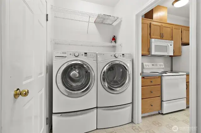 In-Unit Laundry with Appliances Included  No more laundromat trips—enjoy the convenience of your own full-size front-loading washer and dryer, both included with the sale! The laundry area features built-in shelving and is ideally situated just off the kitchen for easy access and efficiency.