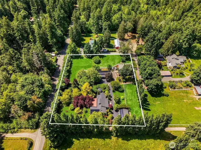 Welcome to the Bainbridge Dream! 2 sunny acres with flat green pastures, a lovely main home, a large carriage house, 3 stall barn with paddocks, a green house and a hen house!