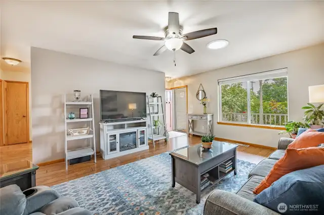 Living Room features skylight and large picture window that looks out to a covered front porch and rose garden