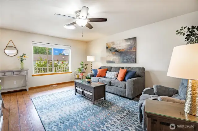 Living Room features skylight and large picture window that looks out to a covered front porch and rose garden