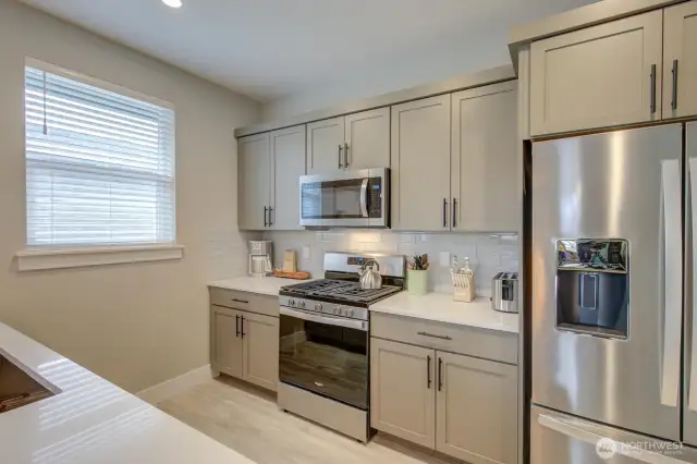 Soft-close cabinets, quartz countertops and stainless steel appliances.