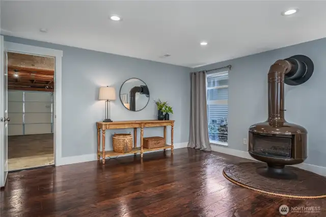 On the lower level, an expansive family room offers space for games, media, and more, complete with a cozy freestanding wood stove.