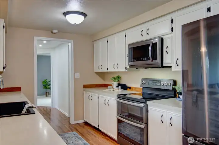 Kitchen with newer appliances, and new kitchen sink.