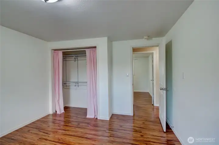 2nd bedroom off of the front hall looking towards the closet & hall,