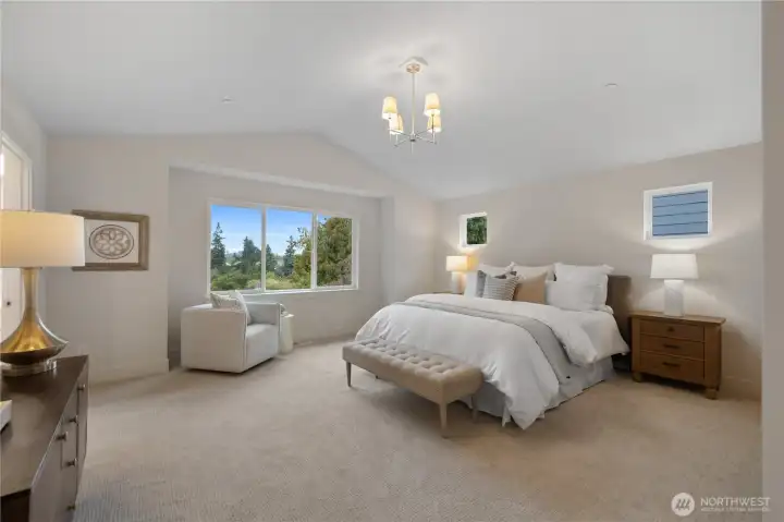 Primary bedroom with vaulted ceilings