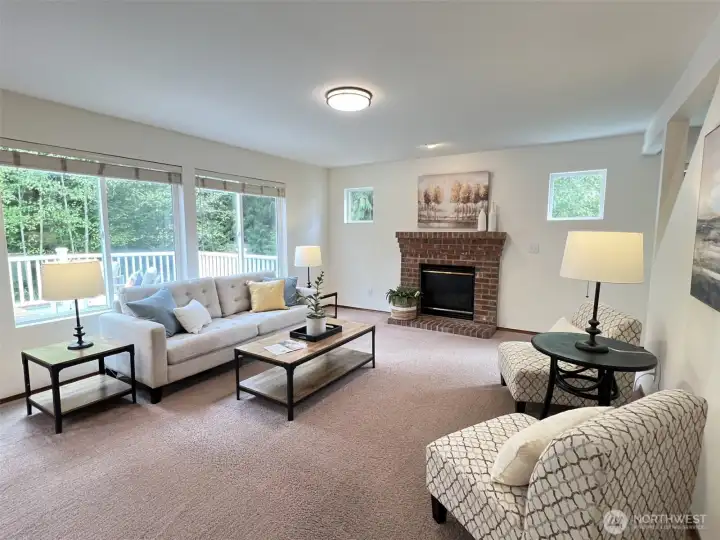Spacious family room with views of the deck and surrounding greenbelt. Gas fireplace adds warmth and comfort on cool autumn evenings.