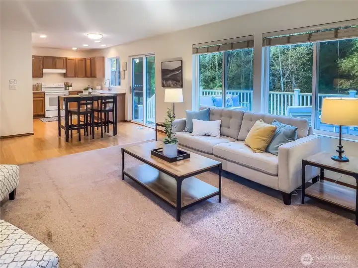 Open layout connects the family room to the kitchen and eating area, creating a great space for cooking, entertaining, and staying connected. Slider opens to the deck for easy al fresco dining with greenbelt views.