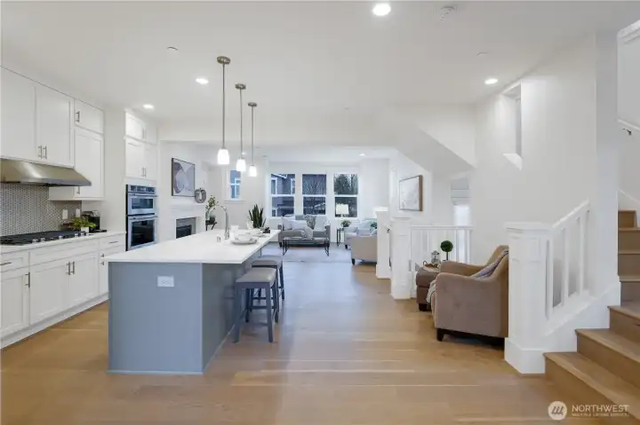 From the dining area looking into the kitchen and the living area beyond.  Note the gorgeous floors and tall ceilings.