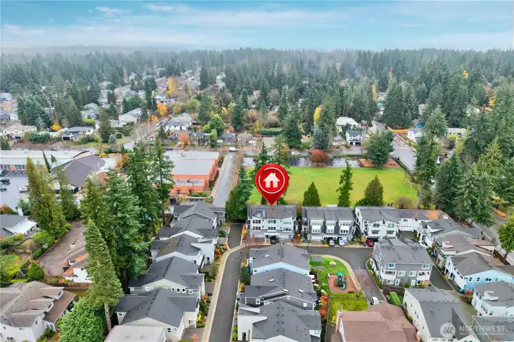 From a higher vantage point, the drone captures sweeping leafy views of Rose Hill stretching to the east.  This elevated perspective highlights the lush surroundings and the serene, tree-lined character of the neighborhood.