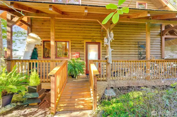 Front entry with wrap around deck. Home fresshly stained and painted May 2026