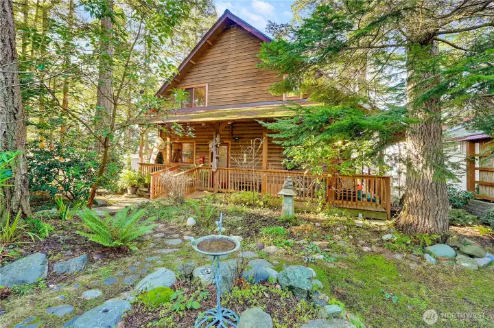Secluded front yard with stone gardens, Douglas Fir and Cedar trees.