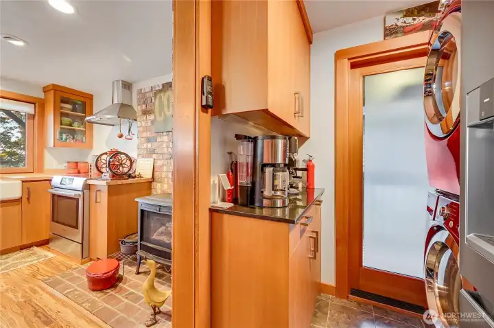 Utility area, all small appliances stay with the home. View of side door to covered deck with BBQ, outdoor cooking stove, and small outdoor refrigerator
