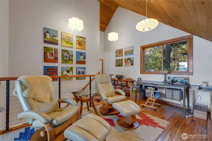 Loft used as the TV room and art studio. Art goes with seller.
