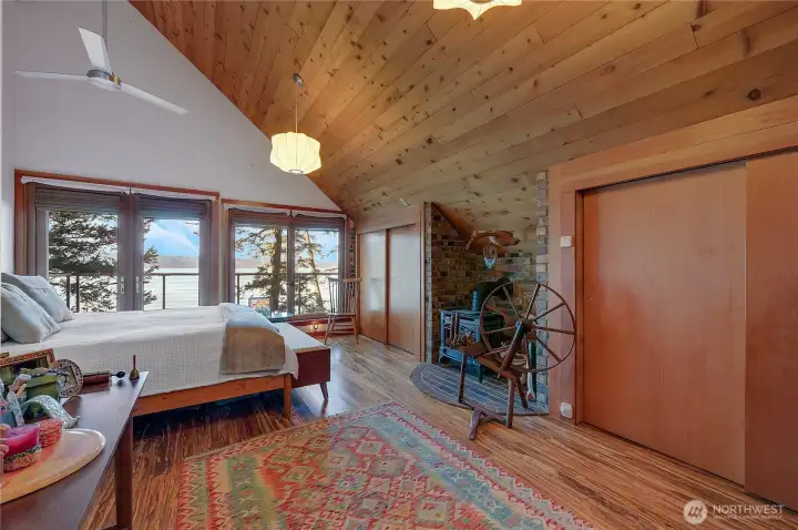 Primary suite, with french doors to private deck, double closets, free standing gas stove, ceiling fan.  Antiques and personal items to go with seller