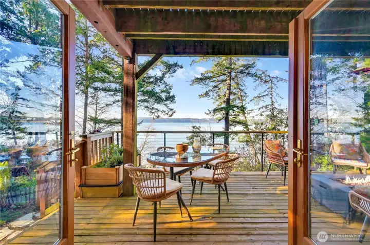 View of deck through french doors in living room. Herb garden to the left
