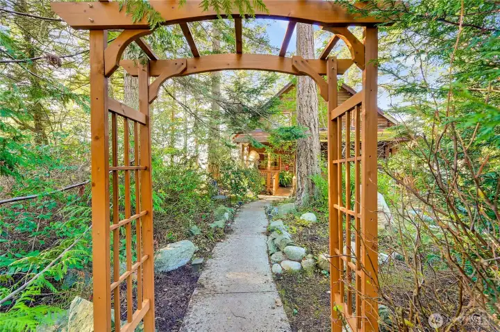 Cedar arch at the beginning of the path to the home
