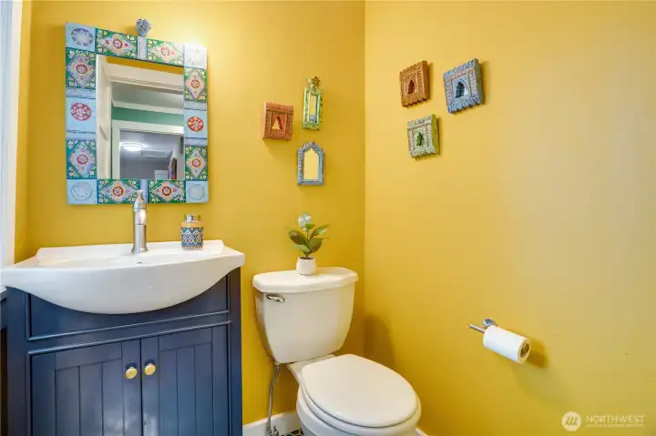 This fully renovated 1/2 bath includes a beautiful tile floor and a privacy glass window.