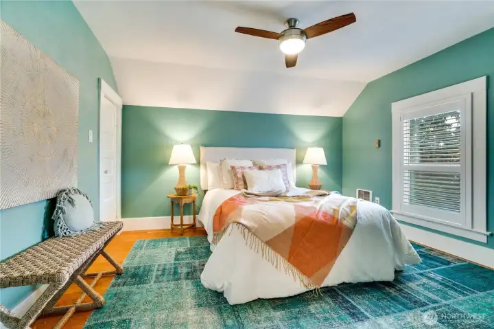 The 2nd floor holds two bedrooms. This back bedroom looks west over the fenced patio, swim spa, and garage.