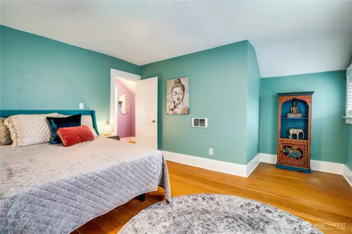 The bedroom corner offers space for a dresser, cozy armchair or loveseat.