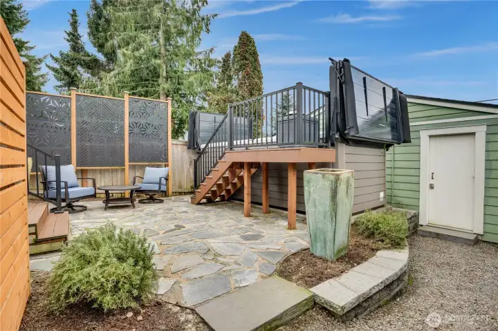 The 16 ft spa is not just a big hot tub. It's an energy-efficient Vita Spa swim spa with a Smart Top, exercise kit, swim tether, 42 hydrotherapy jets, 3 StreamForce stream jets, Bluetooth capability with built-in speakers, a Smart Shield to maximize heat retention, and dual hydraulic lifts for easy opening/closing.