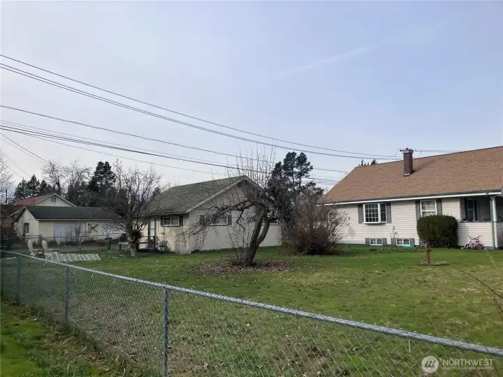 Angle from corner. Showing fenced yard side of home and ADU