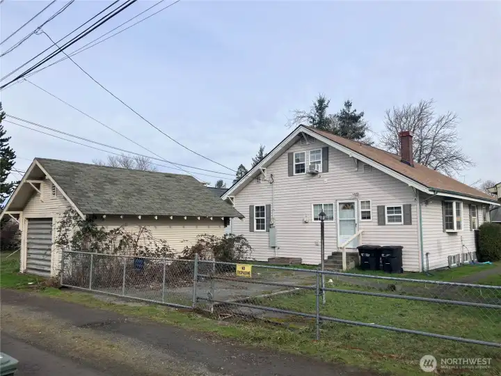 Back of main home and detached garage