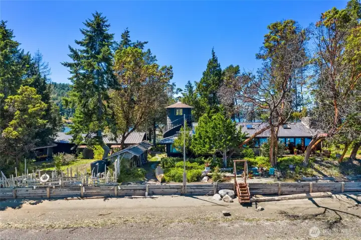 View from the East of Isthmus house, 15,000 gallon water tank, and detached garage & shop. View from the East of Isthmus house, 15,000 gallon water tank, and detached garage & shop.