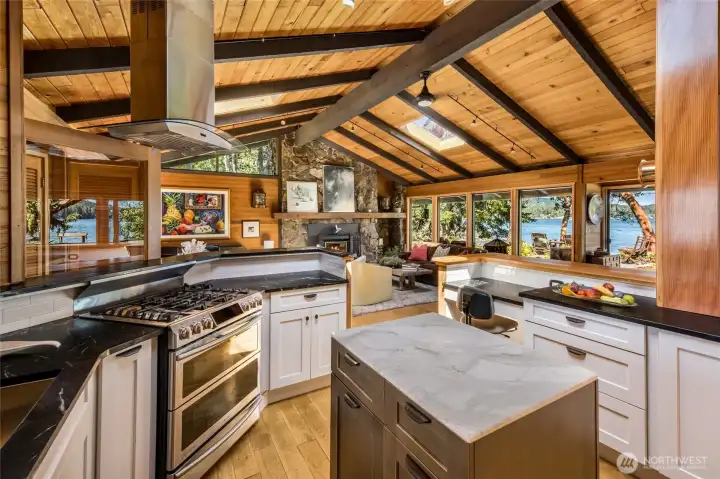 View from the kitchen to living area with wall of windows.