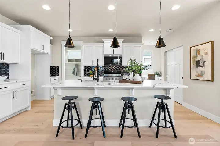 Kitchen with quartz counters and beautiful backsplash
