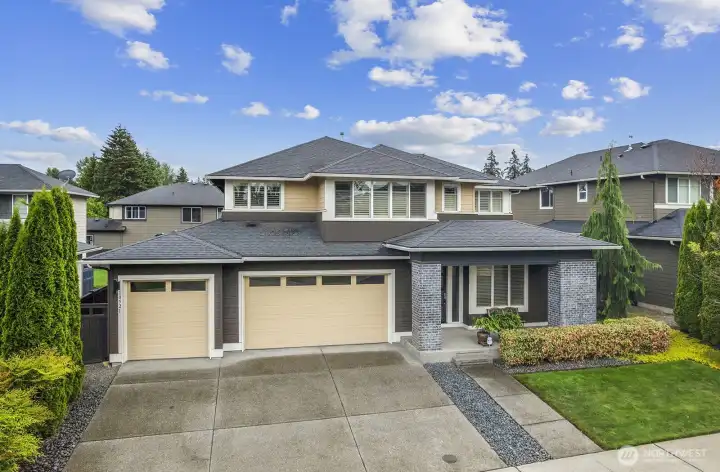 Great front view of the home, showing separate garage doors for 1 car and 2 car garages. Although the entire space is wide open. Covered entry into the house, perfect for a little covered seating area.
