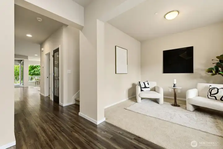 Here from the entry look how large the open office/den space is to enjoy. next is the stairway leading up to the second floor with a door to lots of storage under the stairway. Then the laundry room. Before going back to the kitchen, living and dining areas making up the great room.