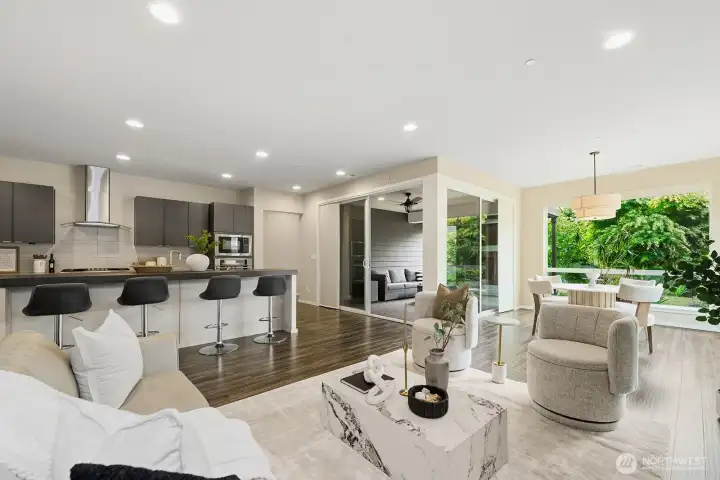 Large open living/dining/kitchen space leads to the covered outdoor space.