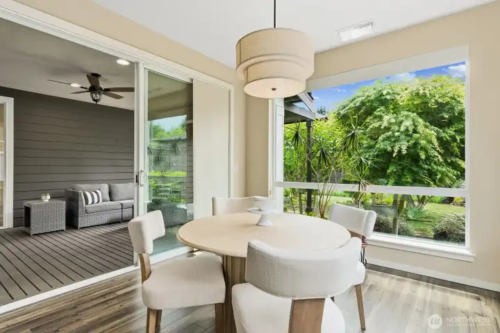 View from the dining area looking out at the Tree giving privacy to your personal space and to the left the slider to your expanded living space out on the Deck/Patio with Gas fireplace.