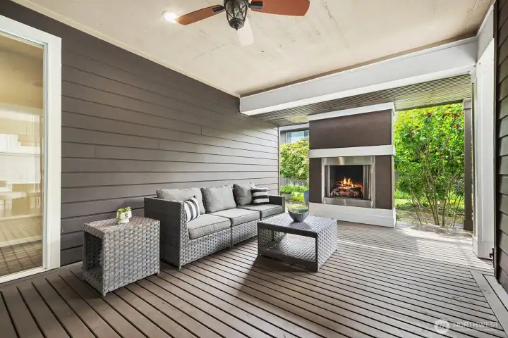 Wow, beautiful covered deck/patio with the gas outdoor fireplace, leading to the great backyard. Sitting in this area is so relaxing and peaceful looking out at all of the vegetation.