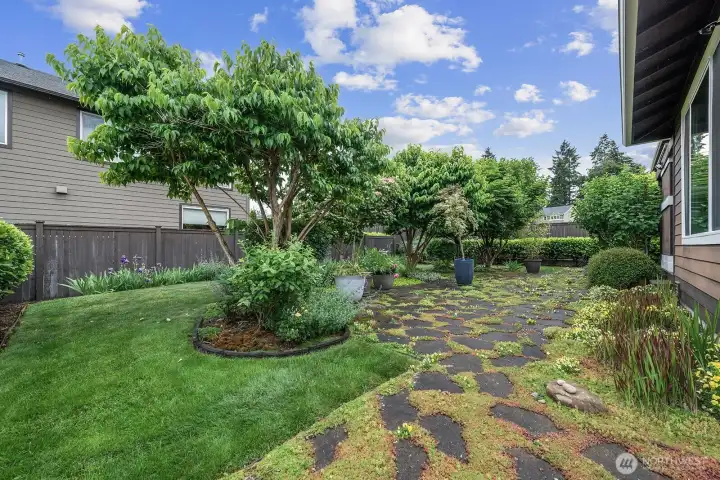 Taken from the eastside of the backyard. Look at all the work the sellers have put in since they bought their home when it was new. The trees and all of the vegation has been added by them.