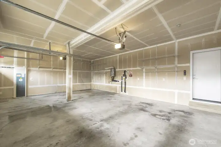 This shows most of the 3 car garage, and the tankless hot water system on the back wall. The door leads into the kitchen area.