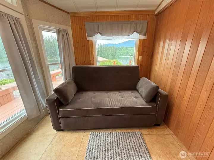 Living room has sliding wall for private sleeping sofa